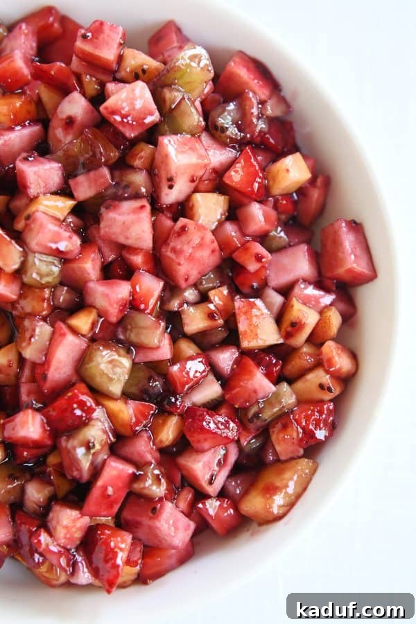 Vibrant Fruit Salsa with Honey-Kissed Cinnamon Crisps 7 Top down view of white shallow bowl with mixed fruit salsa.