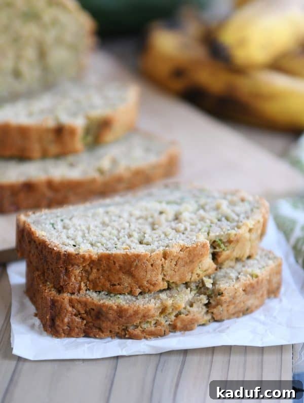 Moist Zucchini Banana Bliss 2 Two generous slices of homemade zucchini banana bread, showcasing its moist crumb and rich, golden-brown crust.