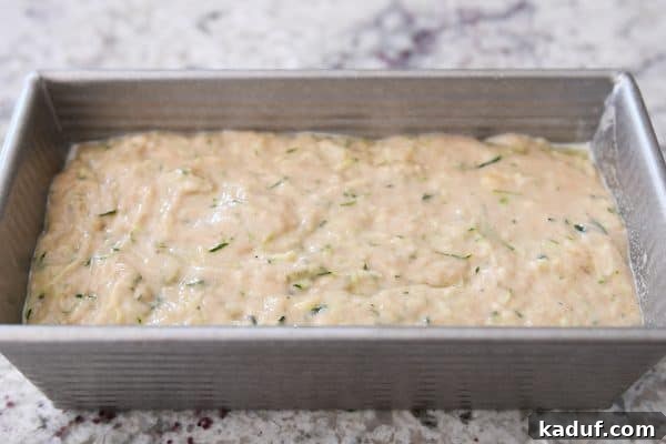 Moist Zucchini Banana Bliss 6 Metal loaf pan filled with unbaked zucchini banana bread batter, smoothed and ready for the oven.
