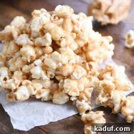 Gooey Peanut Butter Popcorn Bliss 12 A pile of soft and chewy peanut butter caramel popcorn on wax paper, ready to be enjoyed.