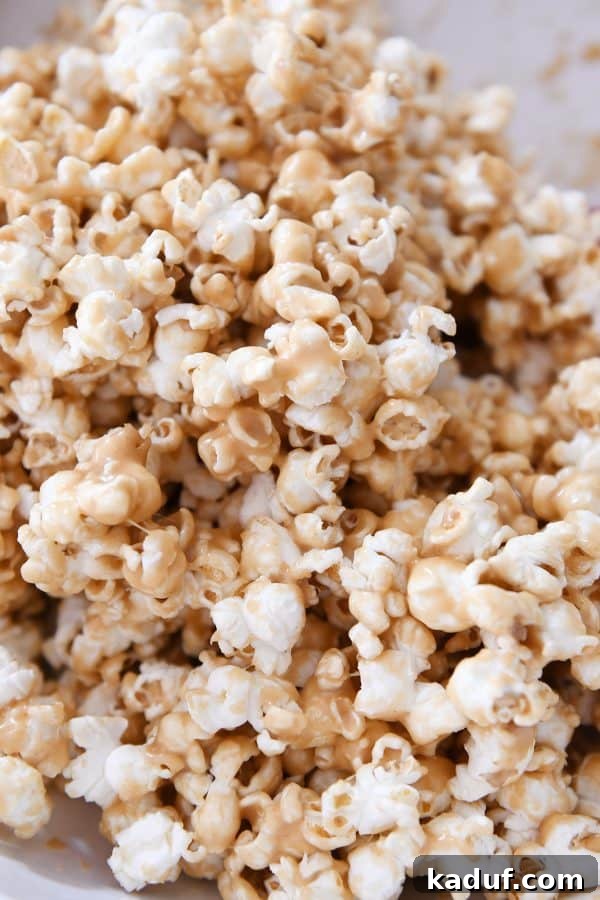 Gooey Peanut Butter Popcorn Bliss 10 Another close-up shot of the soft and chewy peanut butter caramel popcorn, showcasing the rich, even coating and delicious texture.