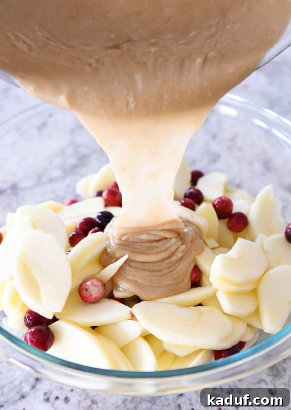 Thanksgivings Beloved Apple Cranberry Pie 7 Pouring caramel sauce over cranberry apple pie.
