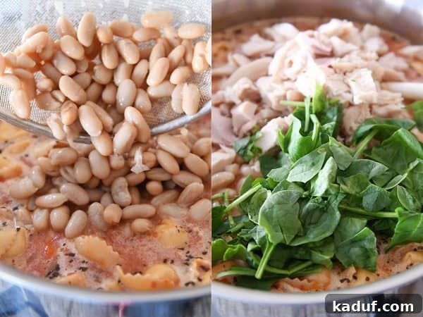 Cooked chicken, white beans, and fresh spinach being added to a pot of creamy Tuscan tortellini soup.