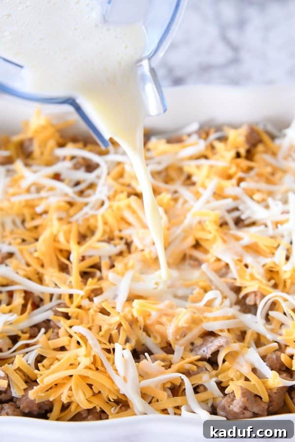 Dreamy Overnight Tater Tot Breakfast 7 Pouring egg mixture on top of tater tot breakfast casserole.