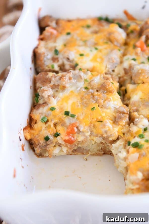 Dreamy Overnight Tater Tot Breakfast 10 Pan of tater tot breakfast casserole with one piece removed.