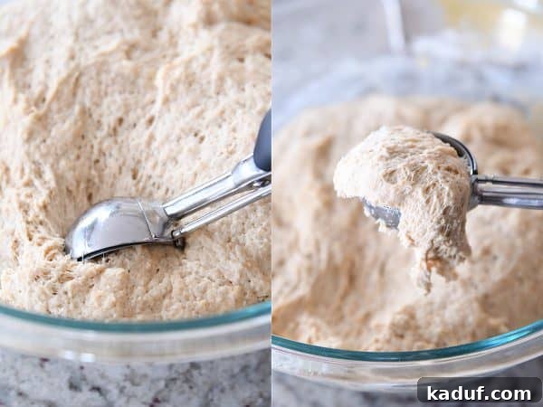 Scooping out wet english muffin dough with cookie scoop.