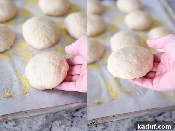 Picking up unbaked english muffins from baking tray.