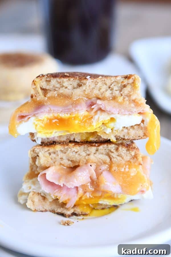Homemade english muffins sandwiched with ham and egg.