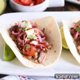 Tender BBQ Pork Tacos Instant Pot Slow Cooker Friendly 9 taco made from instant pot bbq pork taco meat and pickled onions and drizzled with bbq sauce