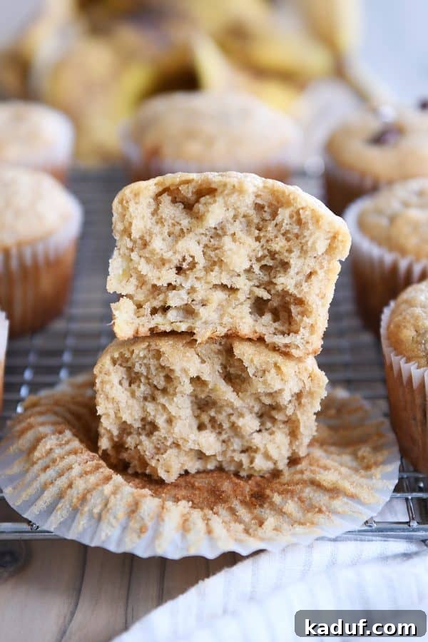 Irresistible Banana Muffins 4 Two halves of a perfectly baked banana muffin stacked, revealing its tender, moist crumb.