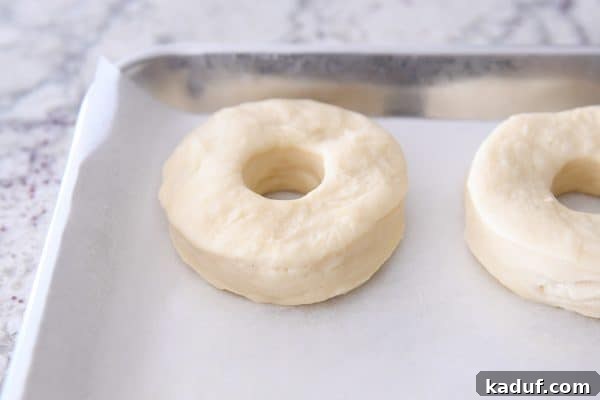 Melt-in-Your-Mouth Homemade Glazed Donuts 16 Homemade donuts rerolled from scraps, showing a slightly uneven texture.