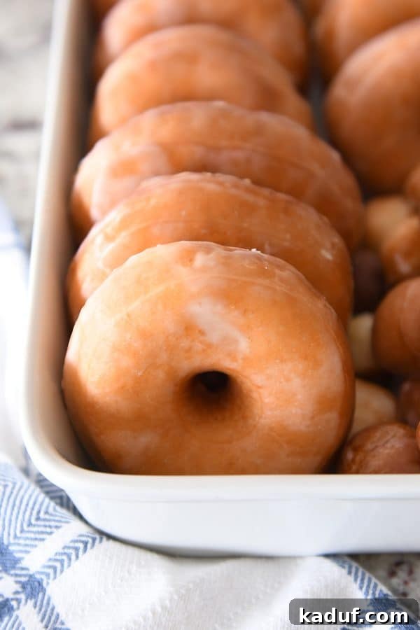 Melt-in-Your-Mouth Homemade Glazed Donuts 26 A pan filled with homemade glazed donuts, looking inviting and delicious.