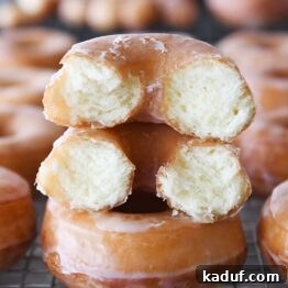 Melt-in-Your-Mouth Homemade Glazed Donuts 27 the best homemade glazed donuts with one broken in half