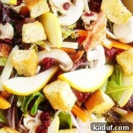 A vibrant gourmet green salad with homemade red wine vinaigrette, perfect for any occasion.