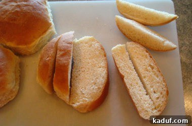 Half-inch bread strips are cut lengthwise on a white cutting board, further reducing their thickness for optimal crouton size and texture.