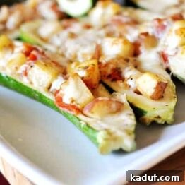 Savory Zucchini Boats 4 A delicious stuffed zucchini boat, golden and cheesy, ready to be served.