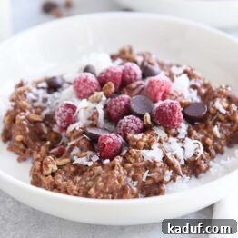 Chocolate Lover's Instant Pot Steel Cut Oats 8 double chocolate steel cut oats in white bowl with coconut, chocolate chips and raspberries
