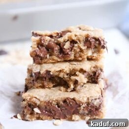 stack of three easy oatmeal chocolate chip coconut cookie bars on white napkin