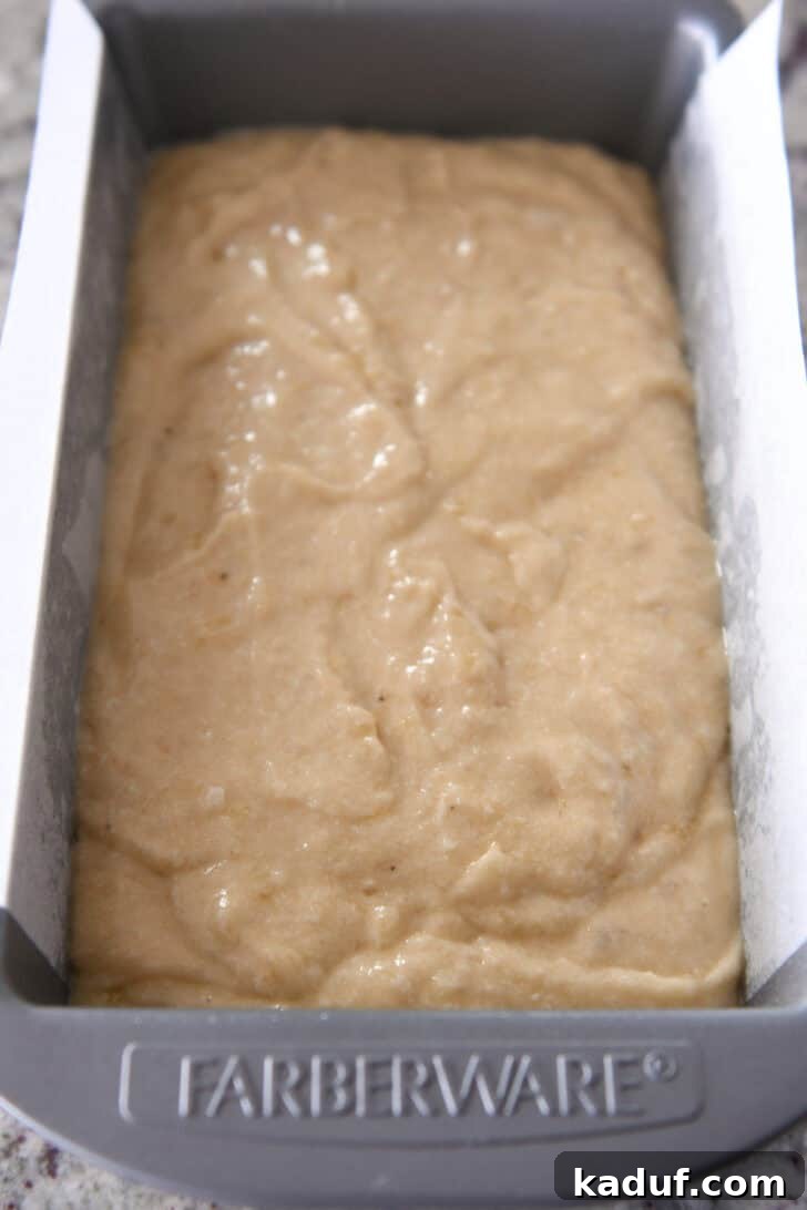 Luscious Buttermilk Banana Bread 7 Top down view of unbaked banana bread batter in a metal Farberware bread pan, smooth and ready for the oven.