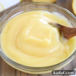 Glass bowl with easy instant pot lemon curd and wooden spoon