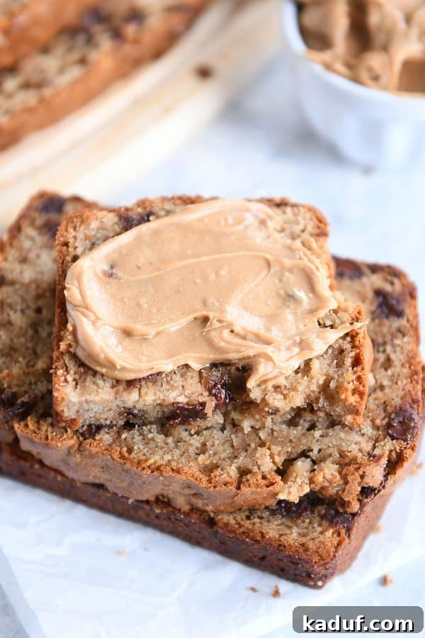 Ultimate Peanut Butter Banana Bread 6 Stack of peanut butter banana bread slices with peanut butter spread on top.