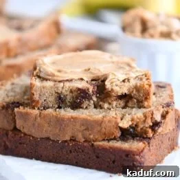 three peanut butter banana bread slices with peanut butter spread on top