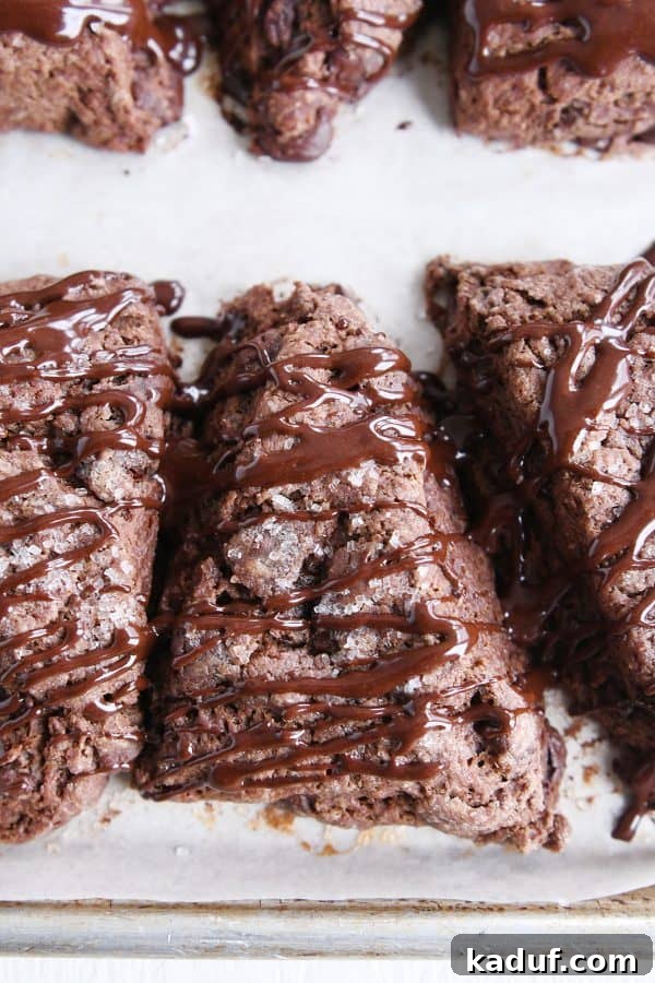 Divine Triple Chocolate Scones 2 Three perfectly baked Triple Chocolate Scones, generously drizzled with chocolate glaze.