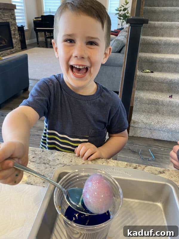 Friday Reflections: Life Lately and Finding My Rhythm 6 A young boy with focused intensity dyes an Easter egg, immersed in a childhood tradition that brings a touch of normalcy and joy.