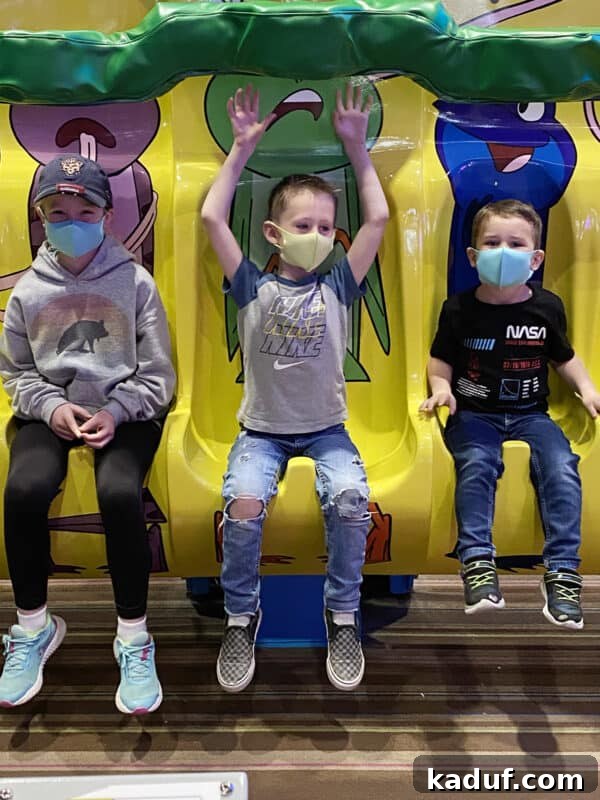 Friday Reflections: Life Lately and Finding My Rhythm 8 Three children joyfully ride an amusement park ride, their laughter contrasting with the author's internal reflections during spring break.