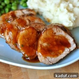 A small image of sliced pork with apricot glaze next to mashed potatoes and peas.