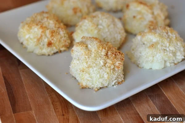 DIY Baked Potato Puffs 2 A rectangular white platter filled with small, golden-brown homemade potato puffs, perfectly baked and ready to eat.