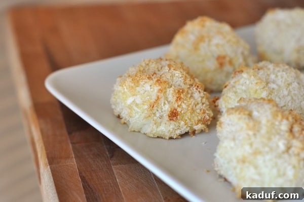DIY Baked Potato Puffs 3 A white plate showcasing several perfectly round and golden potato puffs, highlighting their crispy texture and readiness to be served.