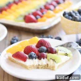 square of the best fruit pizza with bite taken out on white plate