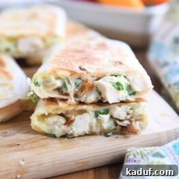 Ultimate Crispy Chicken Bacon Ranch Wraps 9 two halves of crispy wrap stacked on each other on wood cutting board