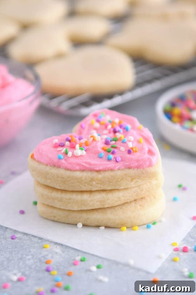 The Ultimate Cutout Sugar Cookie Recipe 2 Heart shaped sugar cookie with pink frosting and sprinkles.