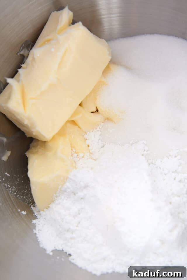The Ultimate Cutout Sugar Cookie Recipe 3 Butter, granulated sugar and powdered sugar in stainless bowl.