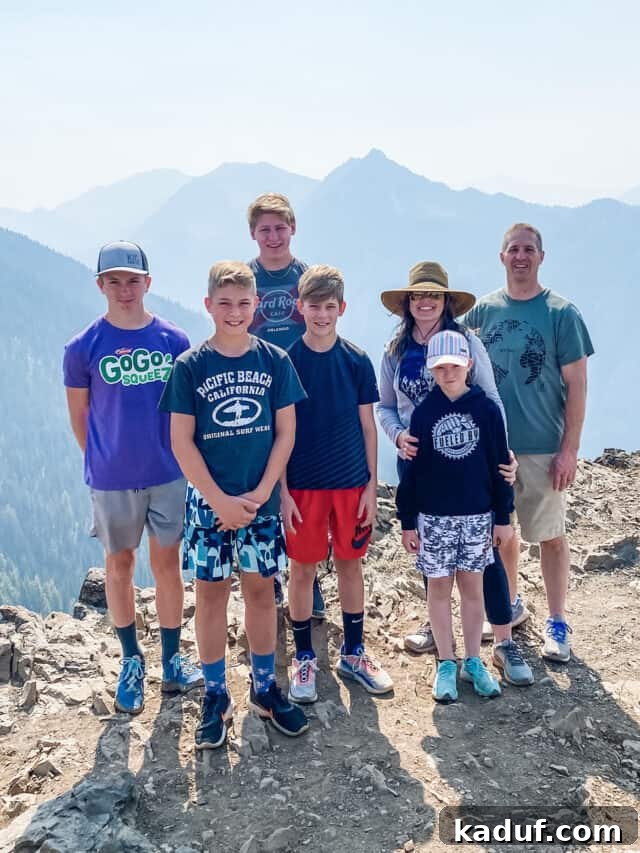 Weekend Whims 10 A family standing at the edge of a scenic mountain overlooking a valley.