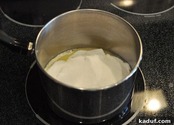 Golden Almond Toffee 8 Melted butter and sugar in a saucepan, being stirred together to create the foundation of almond roca.