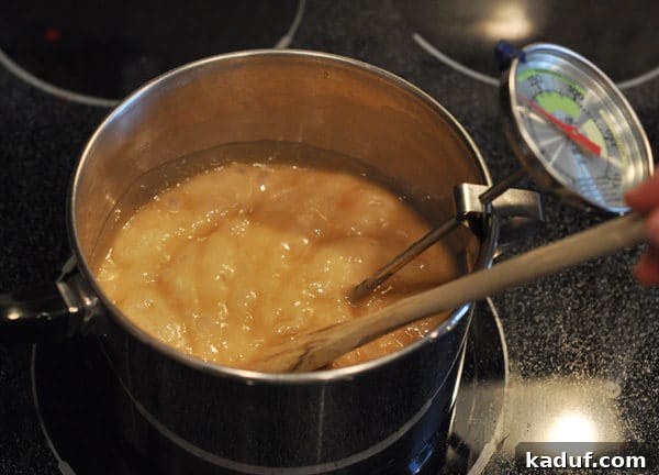 Golden Almond Toffee 13 Golden brown bubbling butter mixture in a saucepan, indicating the toffee is deepening in color and flavor.