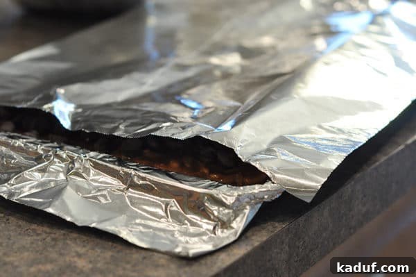 Golden Almond Toffee 18 Cookie sheet lined with tinfoil and tented with foil, a technique to gently melt chocolate chips on hot almond roca.