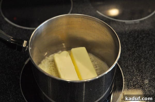 Golden Almond Toffee 7 Two sticks of butter melting in a saucepan, the first step in making rich toffee for almond roca.