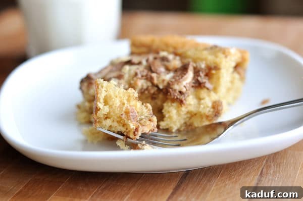Buttery English Toffee Crunch Cake 4 A perfectly sliced piece of Heath Bar cake, showing the moist cake base and the generous, crunchy Heath Bar topping.