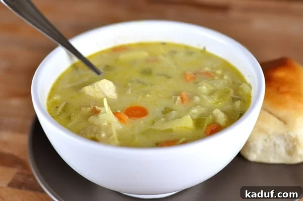 Mulligatawny: A Colonial Classic 2 White bowl full of chicken and vegetable mulligatawny soup, garnished with fresh herbs.