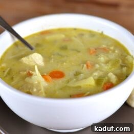 White bowl full of chicken and vegetable mulligatawny soup.