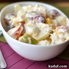 Close-up of Creamy 5-Cup Fruit Salad in a white oval dish, showing a perfect blend of fruits and creamy dressing.