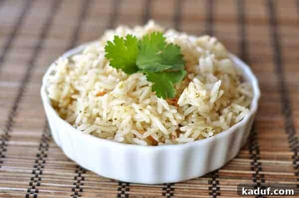 Bright Cilantro Lime Rice 2 A small white bowl filled with cooked cilantro lime rice, garnished with fresh chopped cilantro leaves, ready to be served as a delightful side dish.