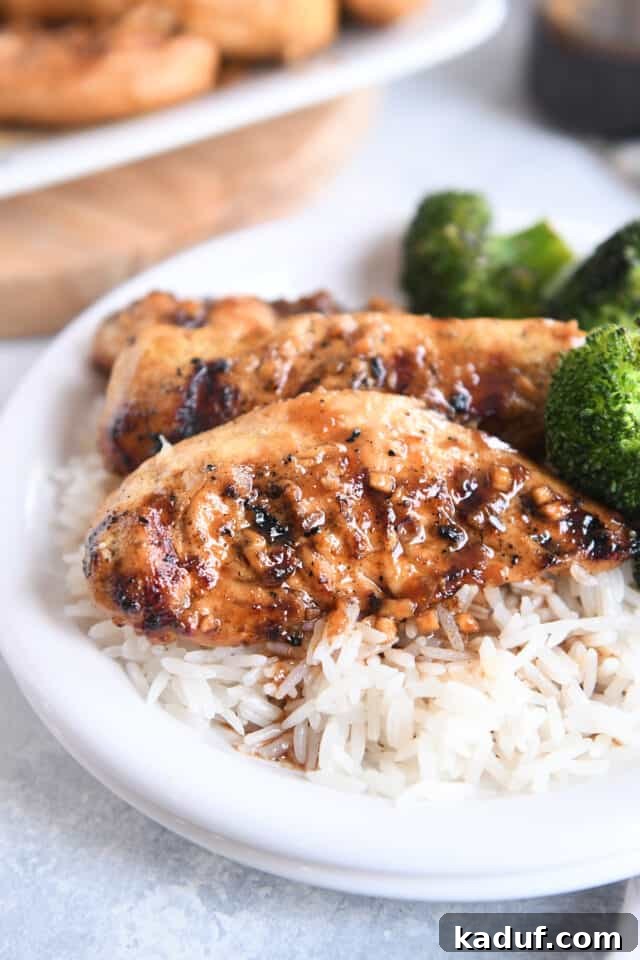 Tropical Ginger-Lime Chicken Tenders with Coconut Rice 5 Two spiced ginger lime chicken tenders on bed of white rice on white plate.