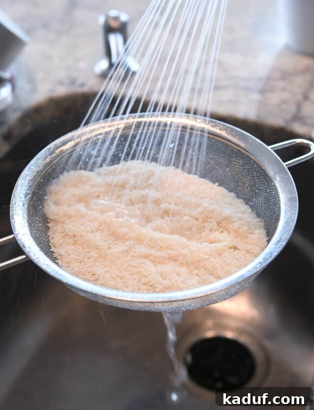 Tropical Ginger-Lime Chicken Tenders with Coconut Rice 7 Rinsing rice in sink in metal colander.