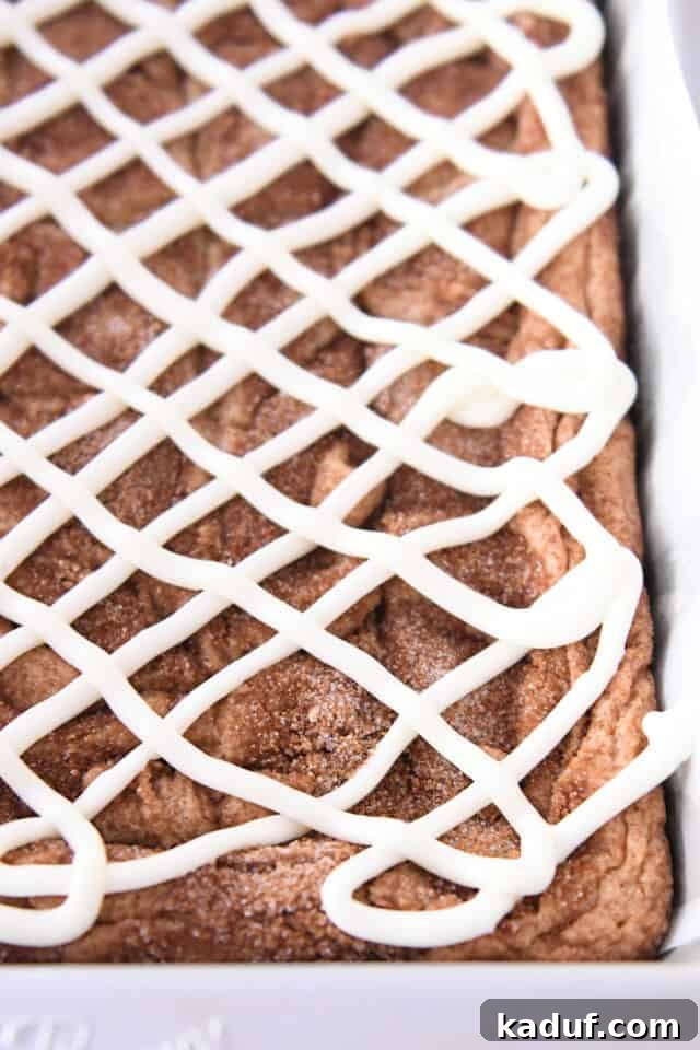 Cinnamon Roll Blondie Bars 5 Iced cinnamon roll blondie bars in 9X13-inch metal pan.