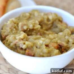 Hearty Slow Cooker Ham Barley and Split Pea Soup 3 Thick split pea and ham soup in a white bowl.